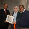 Grinnell board president James Alston accepting a citation from Sarah Morgridge, representing Councilman Jackson's office; Grinnell Centennial Party, October 17, 2010 (Photo: Matthew Spady)