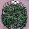 The oval planter in the center of the coutryard is a spot of color year-round.