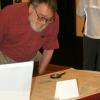 Grinnell resident Joel Rothschild studying a map of northern Manhattan; Grinnell Centennial Exhibition, October 17, 2010 (Photo: Lynne Van Auken)