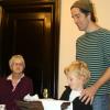 Mason and Robert Leaver read poetry they wrote iin honor of the Grinnell's Centennial;  Alta Waldau looks on; Grinnell Centennial Party, October 17, 2010 (Photo: Lynne Van Auken)