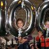 Partiers with the official Centennial Baloons, a gift of Maisha and Tulani Gilyard who grew up at The Grinnell; Grinnell Centennial Party, October 17, 2010 (Photo: Lynne Van Auken)