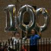 Partiers with the official Centennial Baloons, a gift of Maisha and Tulani Gilyard who grew up at The Grinnell; Grinnell Centennial Party, October 17, 2010 (Photo: Lynne Van Auken)