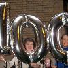 Partiers with the official Centennial Baloons, a gift of Maisha and Tulani Gilyard who grew up at The Grinnell; Grinnell Centennial Party, October 17, 2010 (Photo: Sally Kahan)